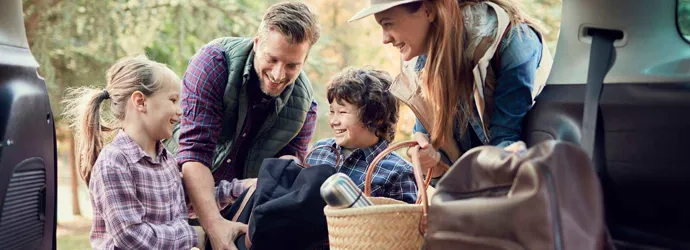 Young family packing up for camping with kids