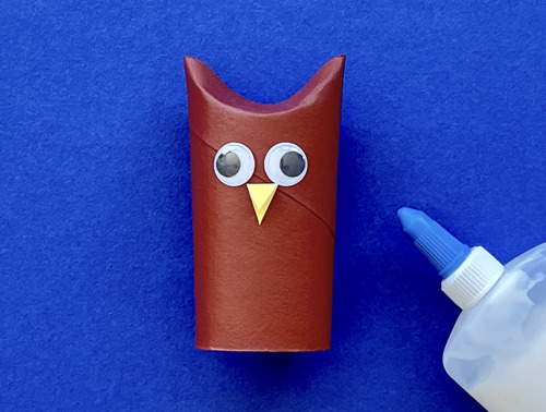 Mother and daughter at desk using toilet roll, paper and pens to make animal crafts