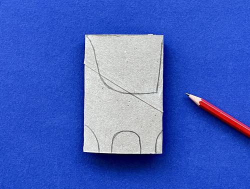 Mother and daughter at desk using toilet roll, paper and pens to make animal crafts