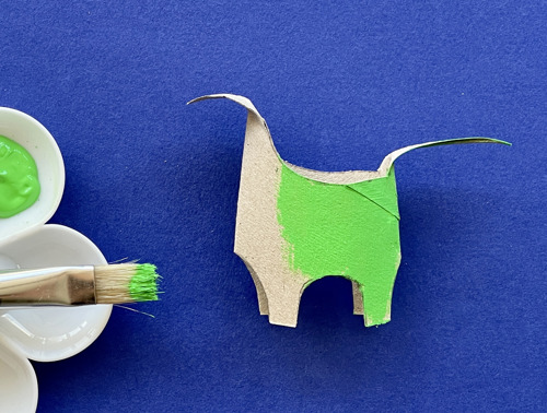 Mother and daughter at desk using toilet roll, paper and pens to make animal crafts