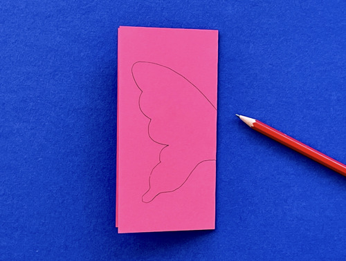 Mother and daughter at desk using toilet roll, paper and pens to make animal crafts