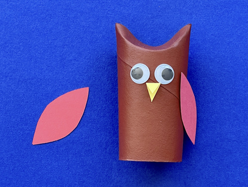 Mother and daughter at desk using toilet roll, paper and pens to make animal crafts