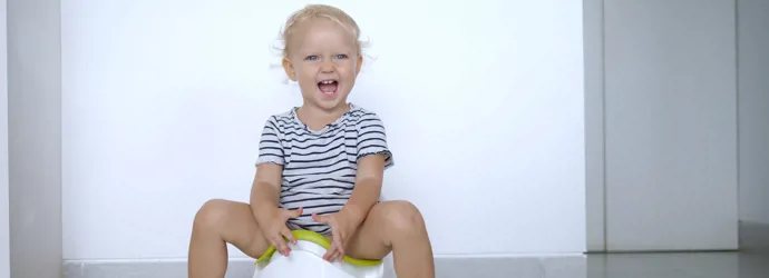 Smiling blond children peeing