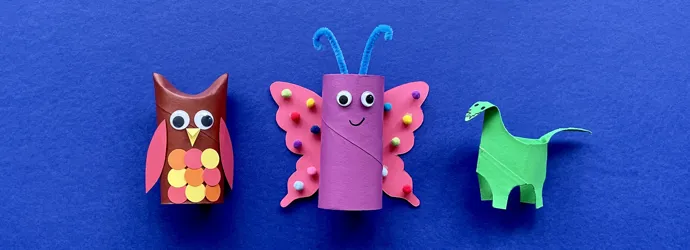 Mother and daughter at desk using toilet roll, paper and pens to make animal crafts